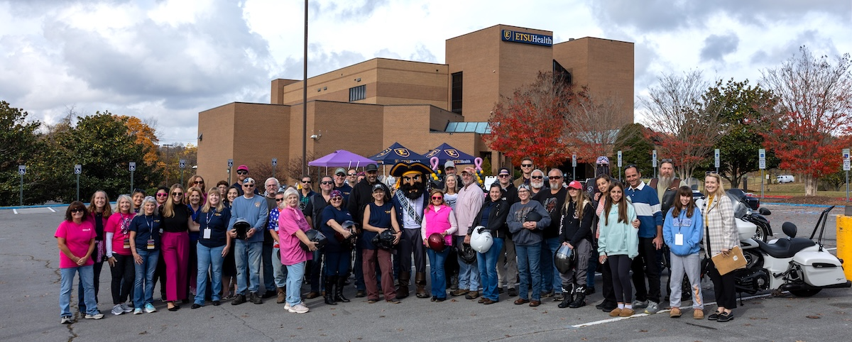 Bikers gather before the 2025 Bikes for Breast Cancer motorcyle run in front of the ETSU Health clinic.