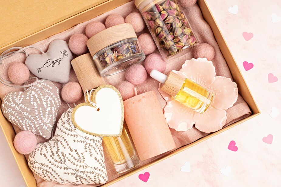 A box full of pink goodies, including soaps and more.