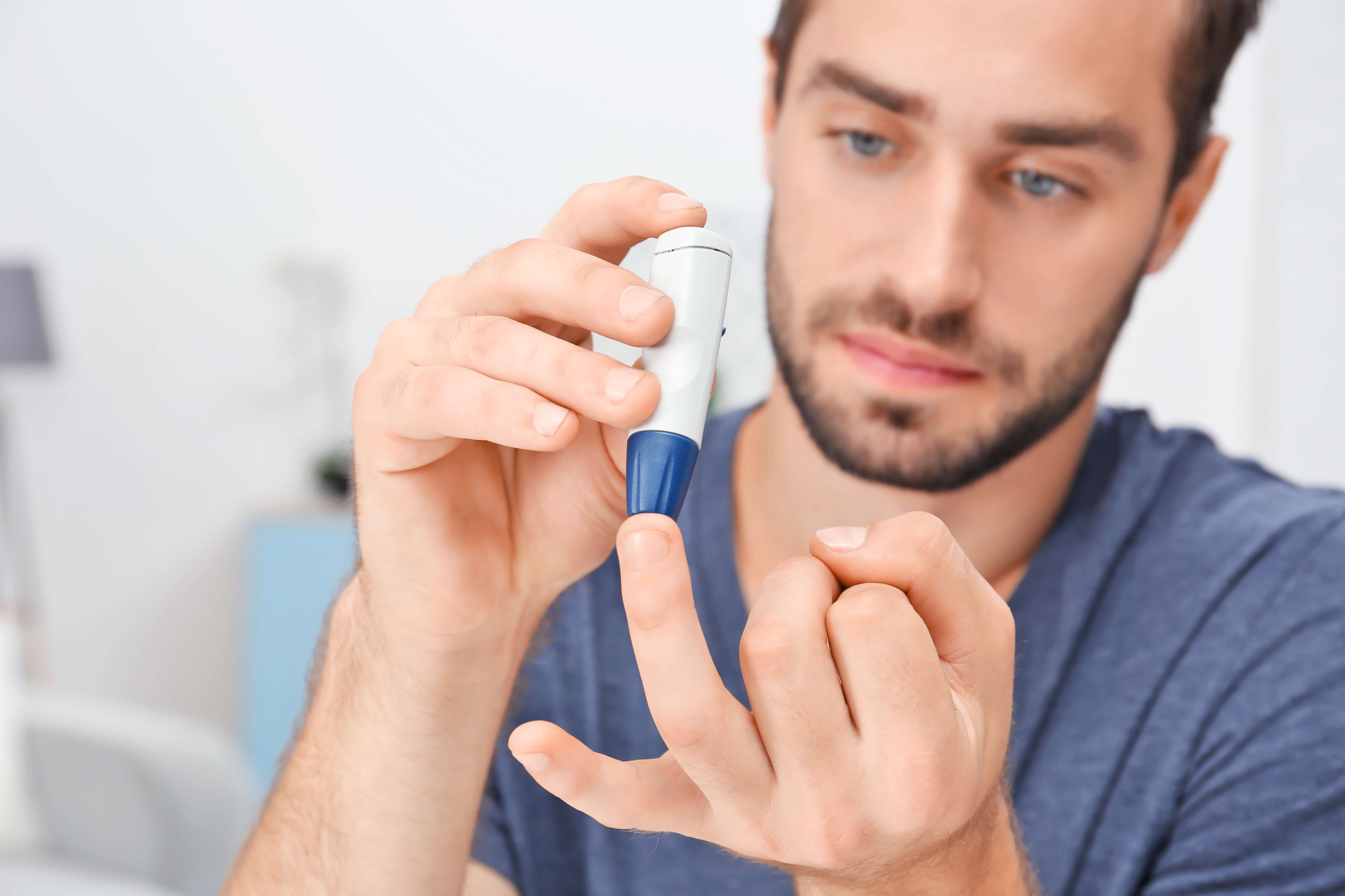 A man poking his finger to test his blood sugar