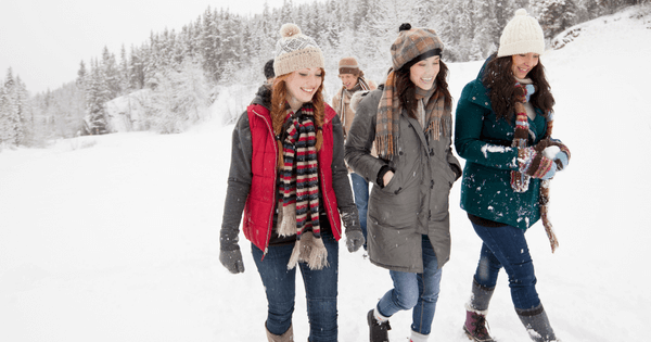 Four friends walking in the snow