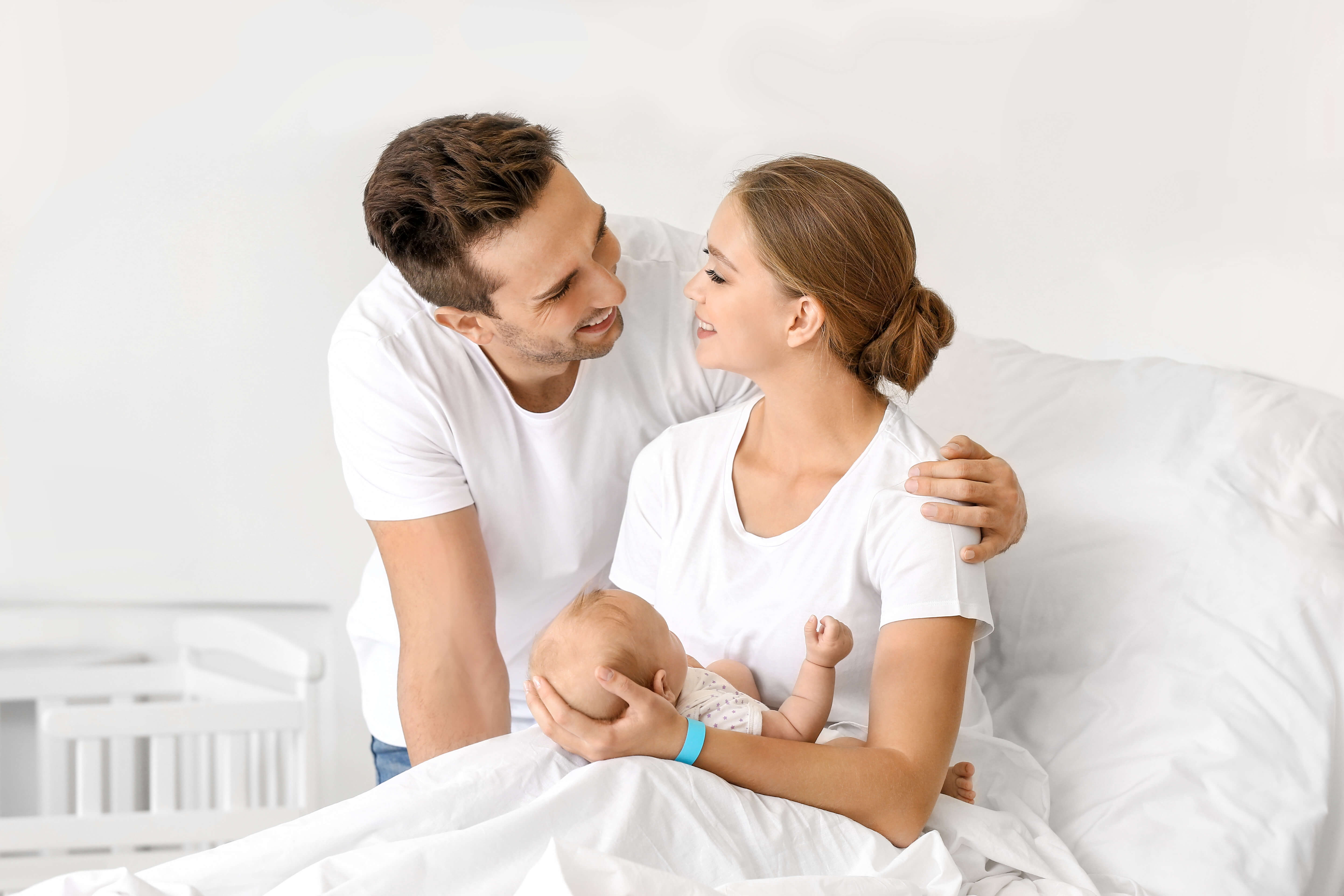 Woman and man hold newborn