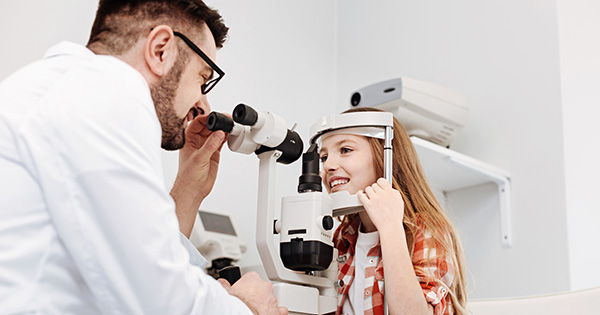 Provider examining young patient's eyes.